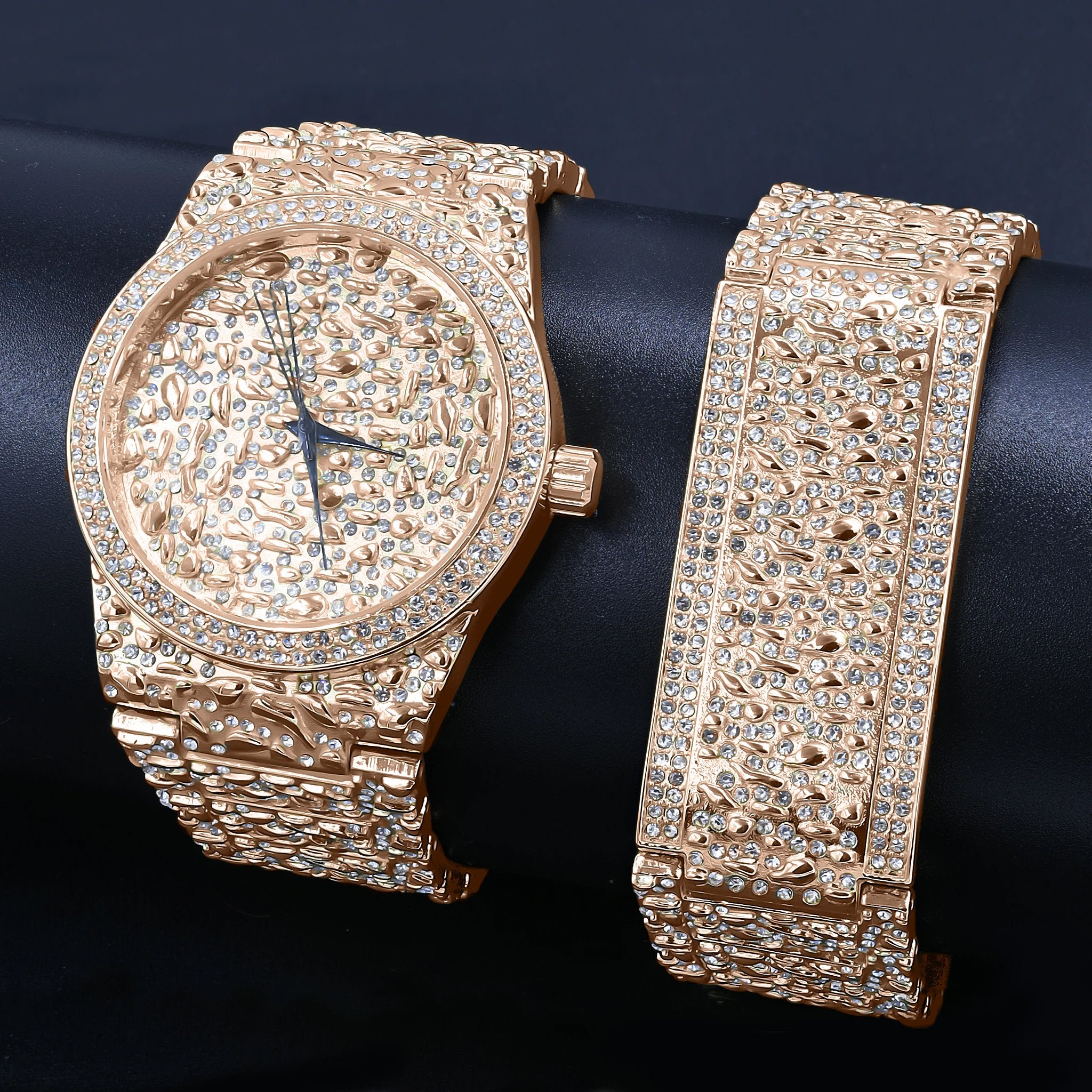 Luxury gold watch and bracelet set on a dark background